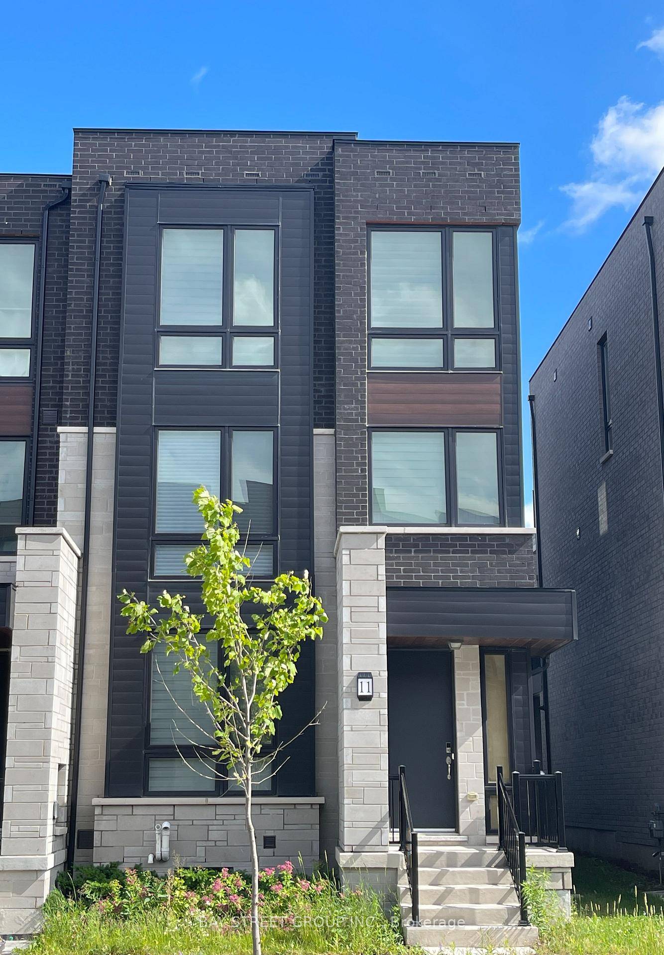 Modern and spacious end unit freehold townhome featuring 4 bedrooms, 5 bathrooms, a double garage plus 2 additional parking spaces total 4.