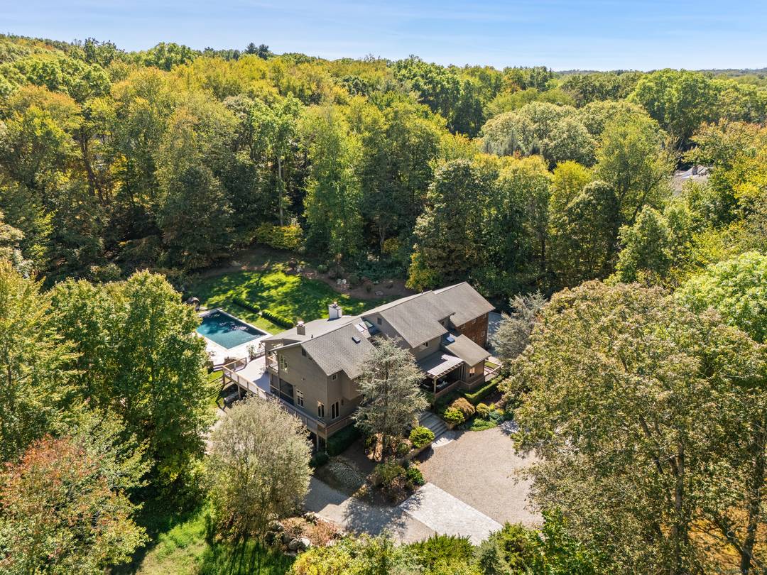 Set on more than two acres of exquisite, park like property in the coveted Red Coat estate section of Westport, this spectacular modern home with a glorious gunite pool offers ...