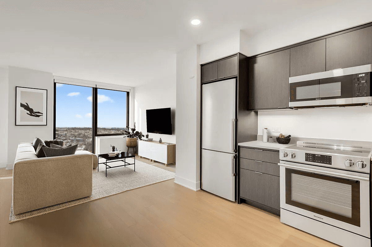 High floor corner two bedroom, one bathroom apartment with floor to ceiling windows, views of the Manhattan Harbor, and plenty of natural light.