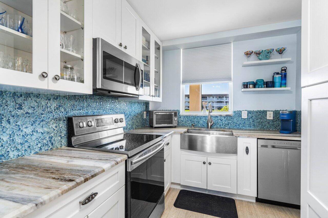 Welcome to this meticulously updated waterfront condo in North Palm Beach, where luxury meets convenience.