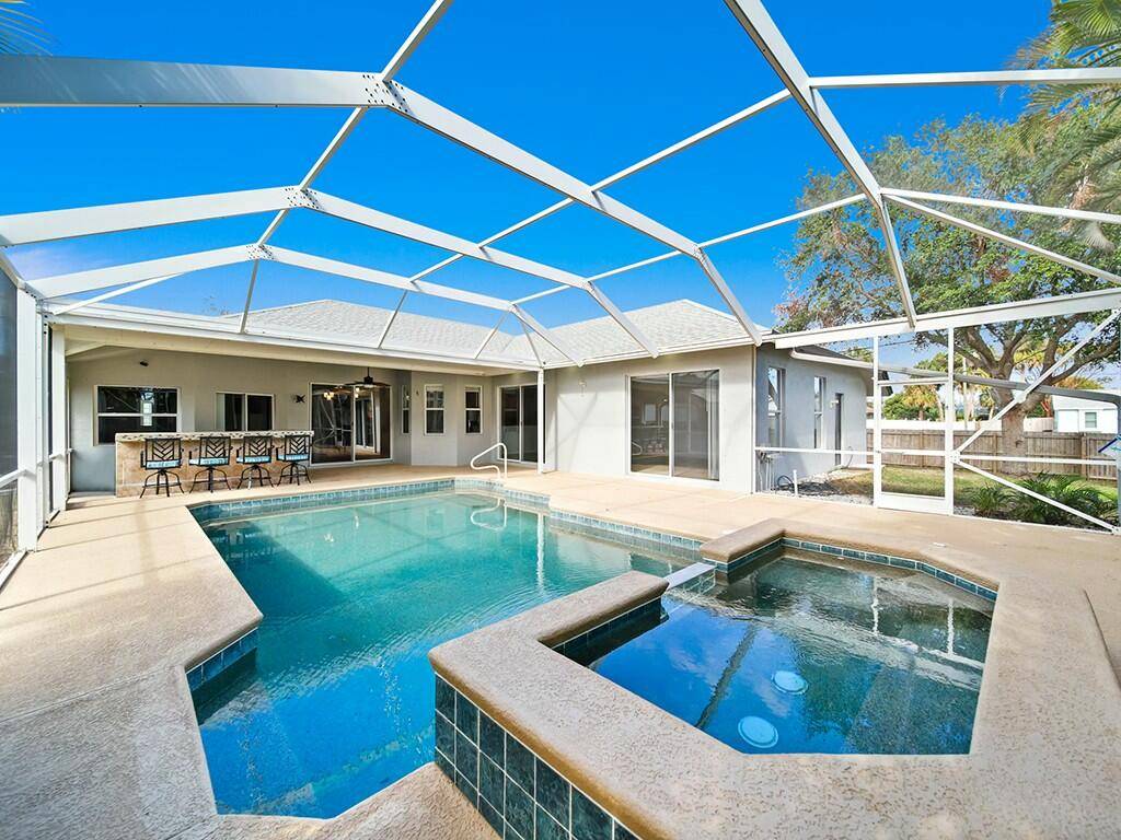 Welcome to your solid concrete, screened in pool home, perfectly situated on a spacious corner lot of nearly 1 3 acre with a convenient circular driveway for easy access and ...