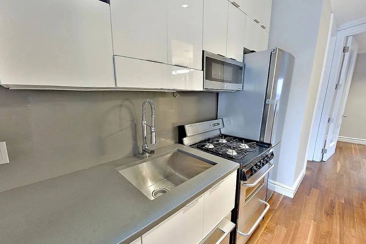 This updated four bedroom, two bath residence offers a seamless blend of style and function, featuring a private roof deck, modern kitchen, and in unit washer and dryer.