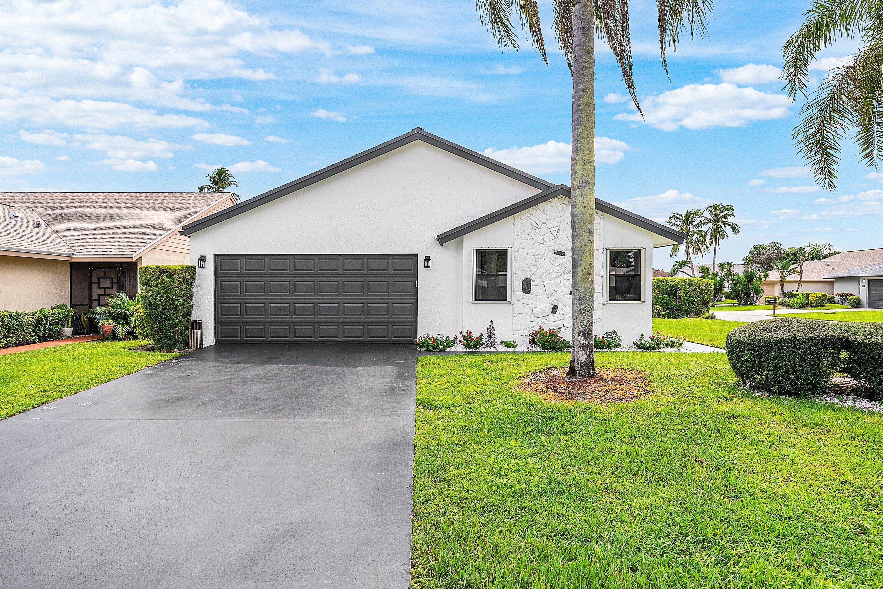 Welcome to this beautifully renovated 3 bedroom, 2 bath home with a spacious two car garage, nested in the highly sought after gated community of Rainberry Bay in Delray Beach.