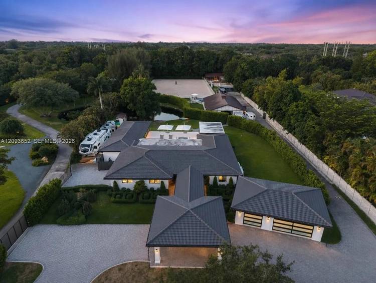 Nestled in the sought after Sunshine Ranches neighborhood of Southwest Ranches, this charming country style turnkey equestrian estate sits on 2.