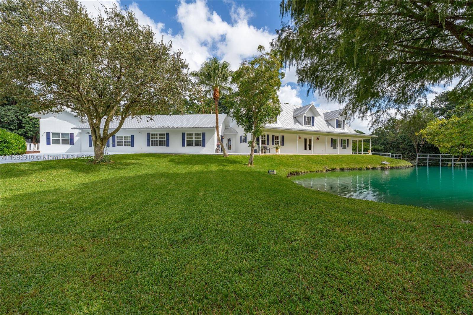 An equestrian dream in Southwest Ranches, this 4, 400 sf ranch style estate sits at the end of a private cul de sac on 2.