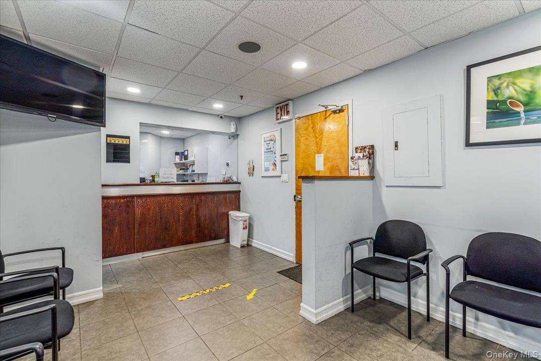 This bright and efficiently laid out office features a welcoming reception and waiting area, multiple private exam rooms, consultation space, and a dedicated restroom.