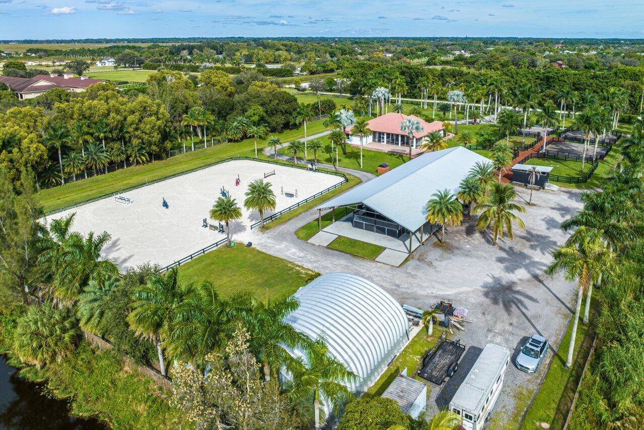 Barn with studio lounge, tack room, feed room, 4 covered wash stalls w fans, RV hookups.