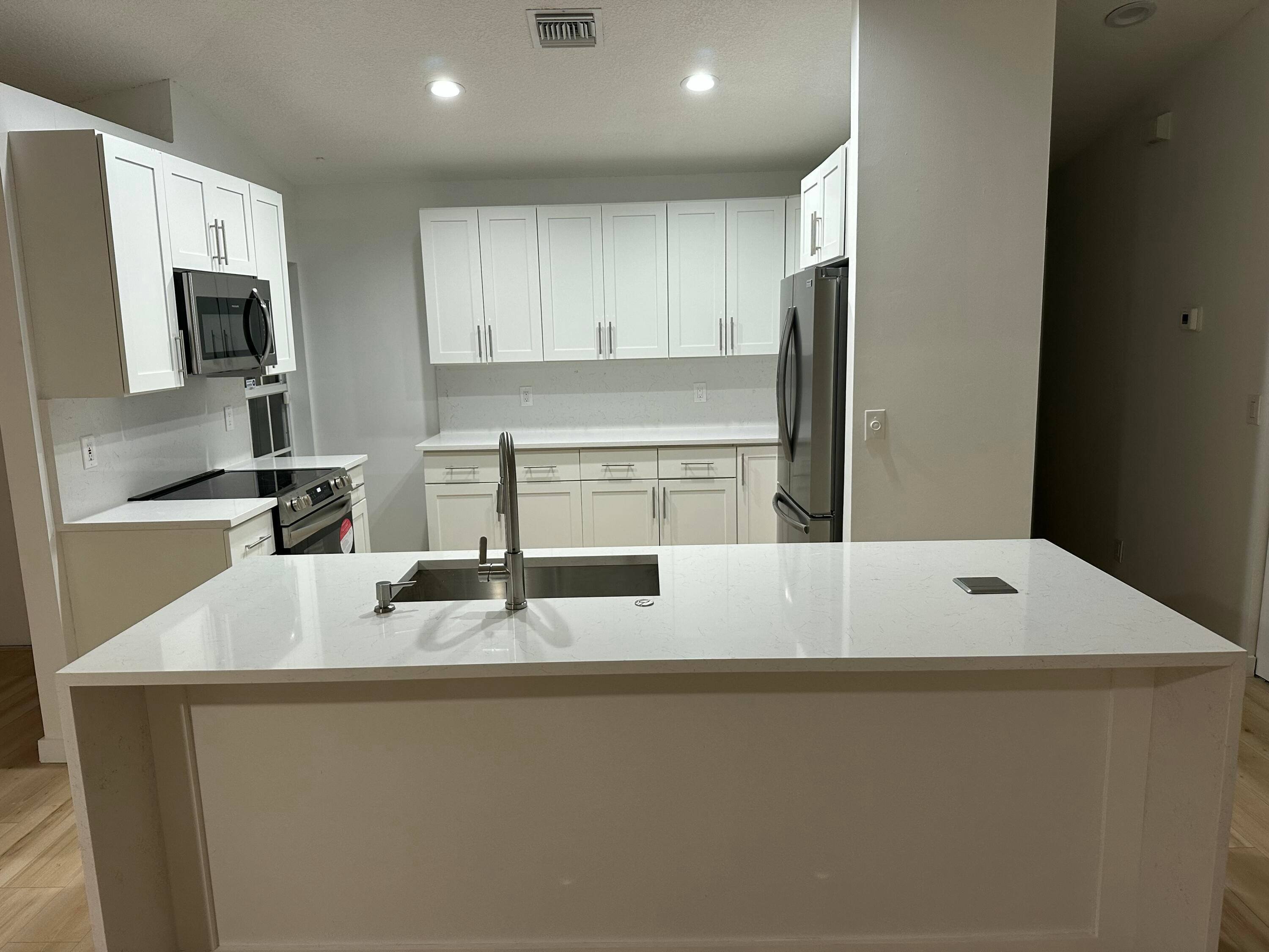 RENOVATED 3 2 SINGLE FAMILY HOME IN GATED COMMUNITY FEATURING A NEW ROOF, NEW KITCHEN, NEW FLOORS, NEW APPLIANCES.