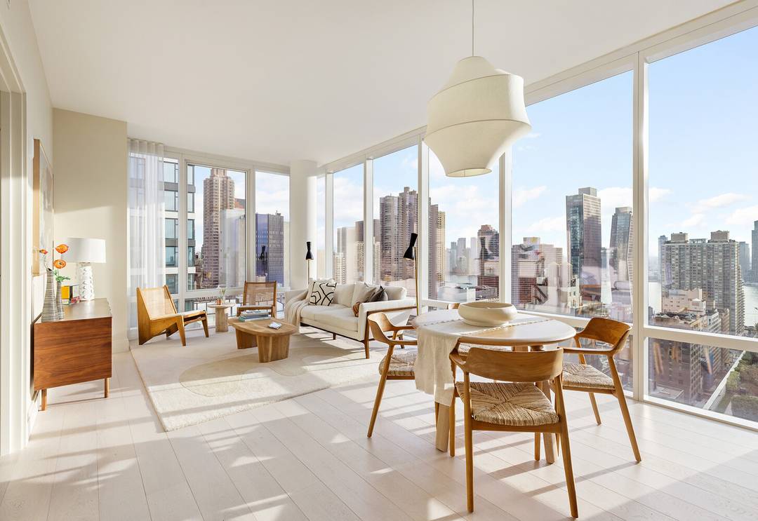Luxury corner home with 10' floor to ceiling windows and expansive views of the River, Manhattan skyline and Long Island City.