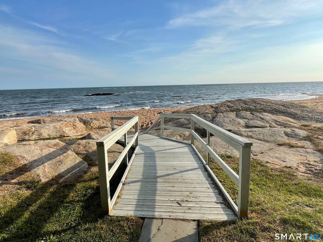 DIRECT WATERFRONT 1st floor end unit on the sandy beach ; open, renovated KIT w granite counters ; LR DR combo with wood burning FP and sliders to deck overlong ...