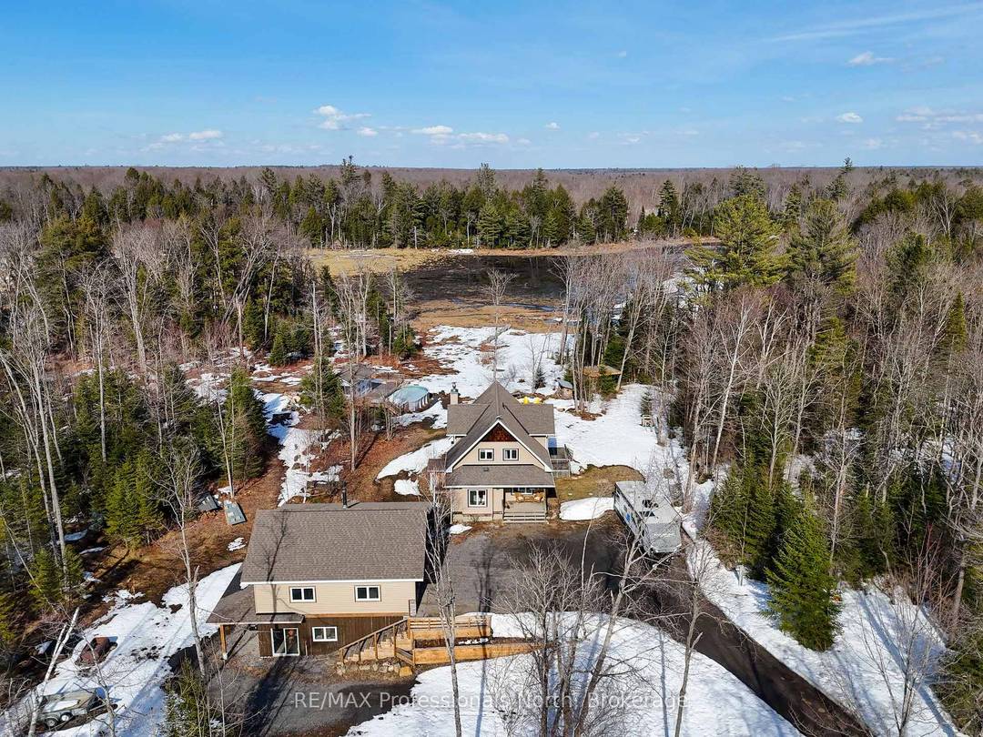 Just east of Bracebridge, this exceptional family home offers privacy, space, and convenience on a picturesque 8.