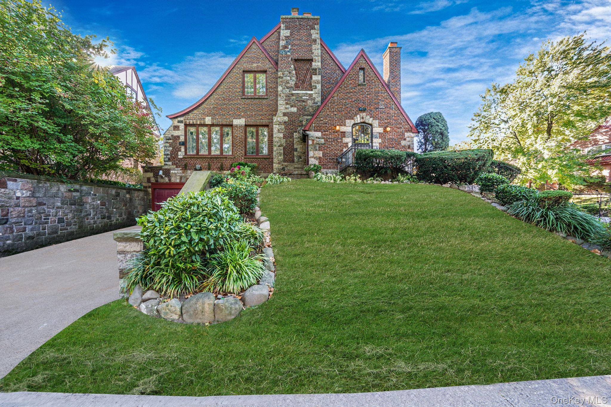 Set on an expansive 60 x 102 lot, this classic Tudor style residence captures timeless architectural beauty with its brick and stone facade.