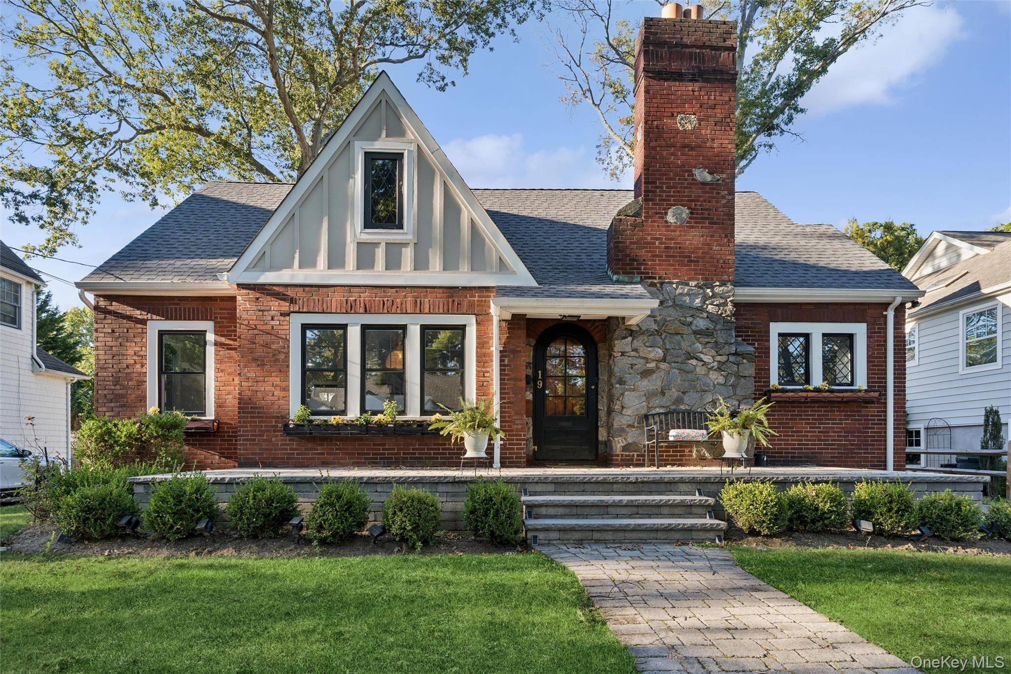 Welcome to this beautifully renovated Tudor style home nestled in the heart of Merrick Woods.