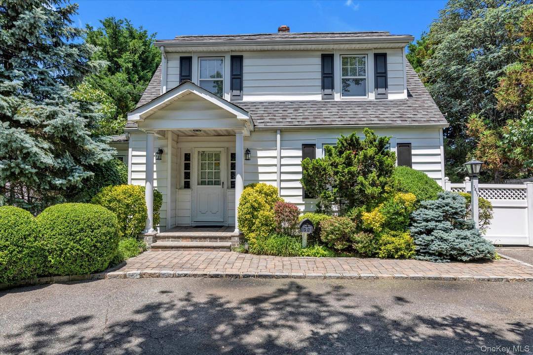 Merrick Charming and Beautiful Colonial home with relaxing pool featuring living room with a working wood burning fireplace, Chef's kitchen with Viking Gas stove, Miele amp ; KitchenAid appliances, custom ...