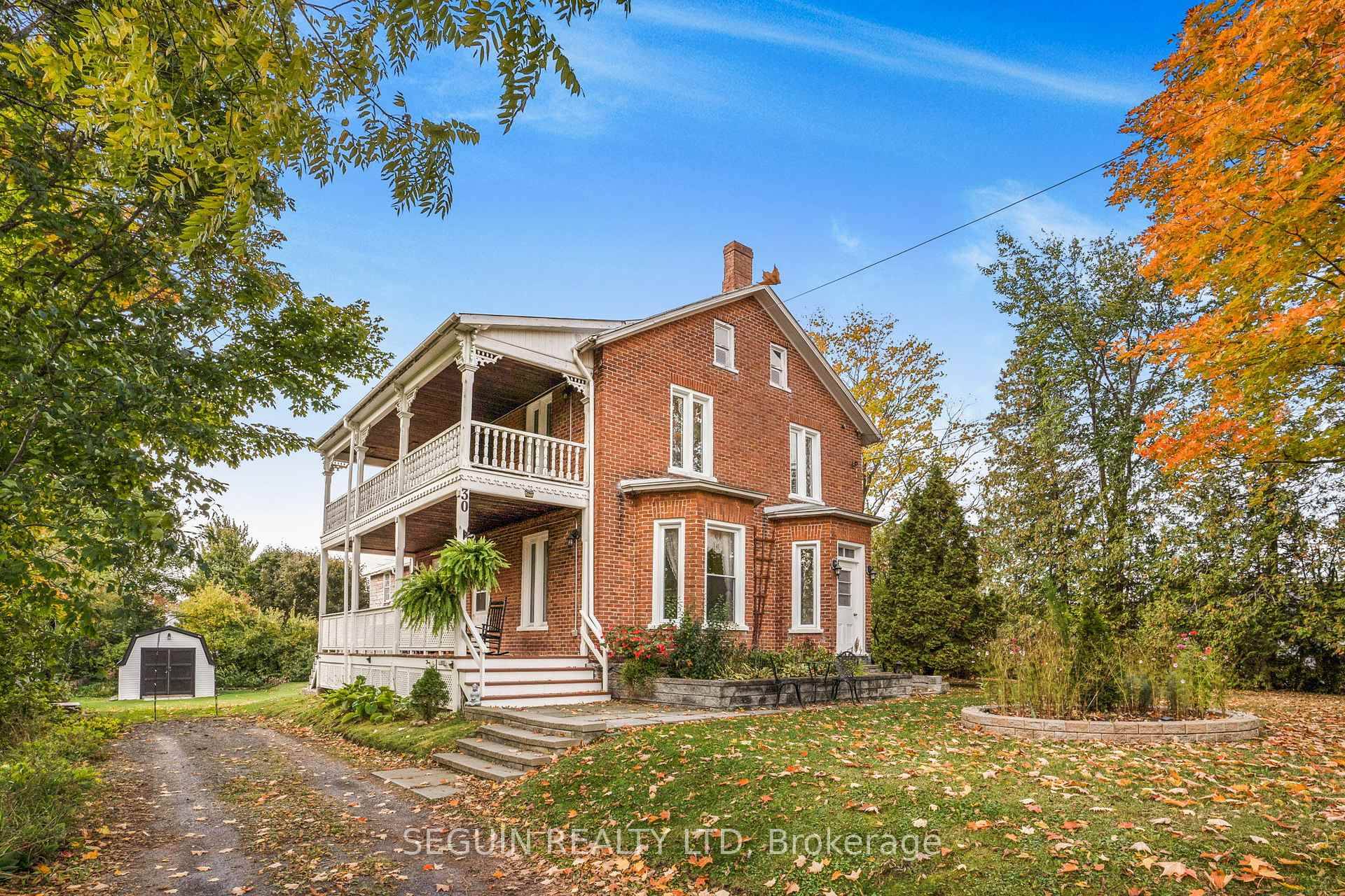 BEAUTIFUL RED BRICK VICTORIAN HOME LOCATED ON AN OVERSIZED LOT surrounded by mature trees, perennials, and 2 driveways for ample parking space.