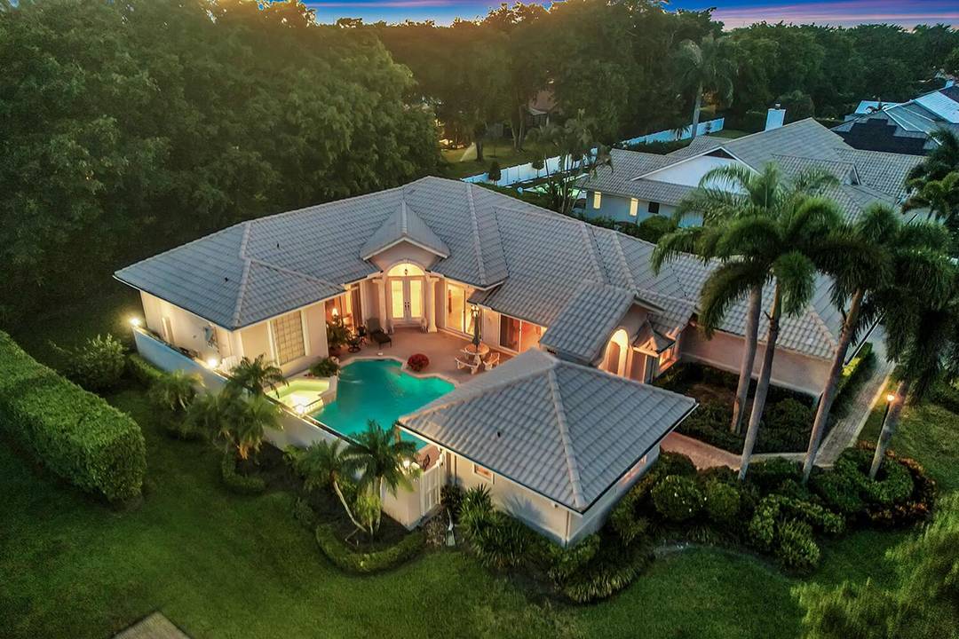 EXCLUSIVE Gated Pine Tree Golf Club living in this 4BR 3BA courtyard home as every room opens to water views of the private courtyard pool spa, creating a refined indoor ...