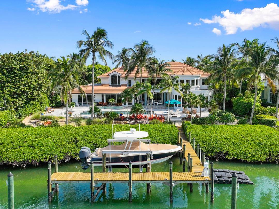 Discover this expansive Waterfront Estate located on a secluded barrier island in prestigious Sailfish Point Country Club.