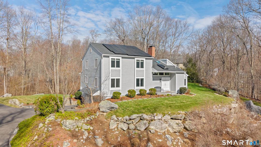Set along a quiet private drive in North Stamford, this thoughtfully updated home offers a rare sense of calm, privacy, and effortless living.