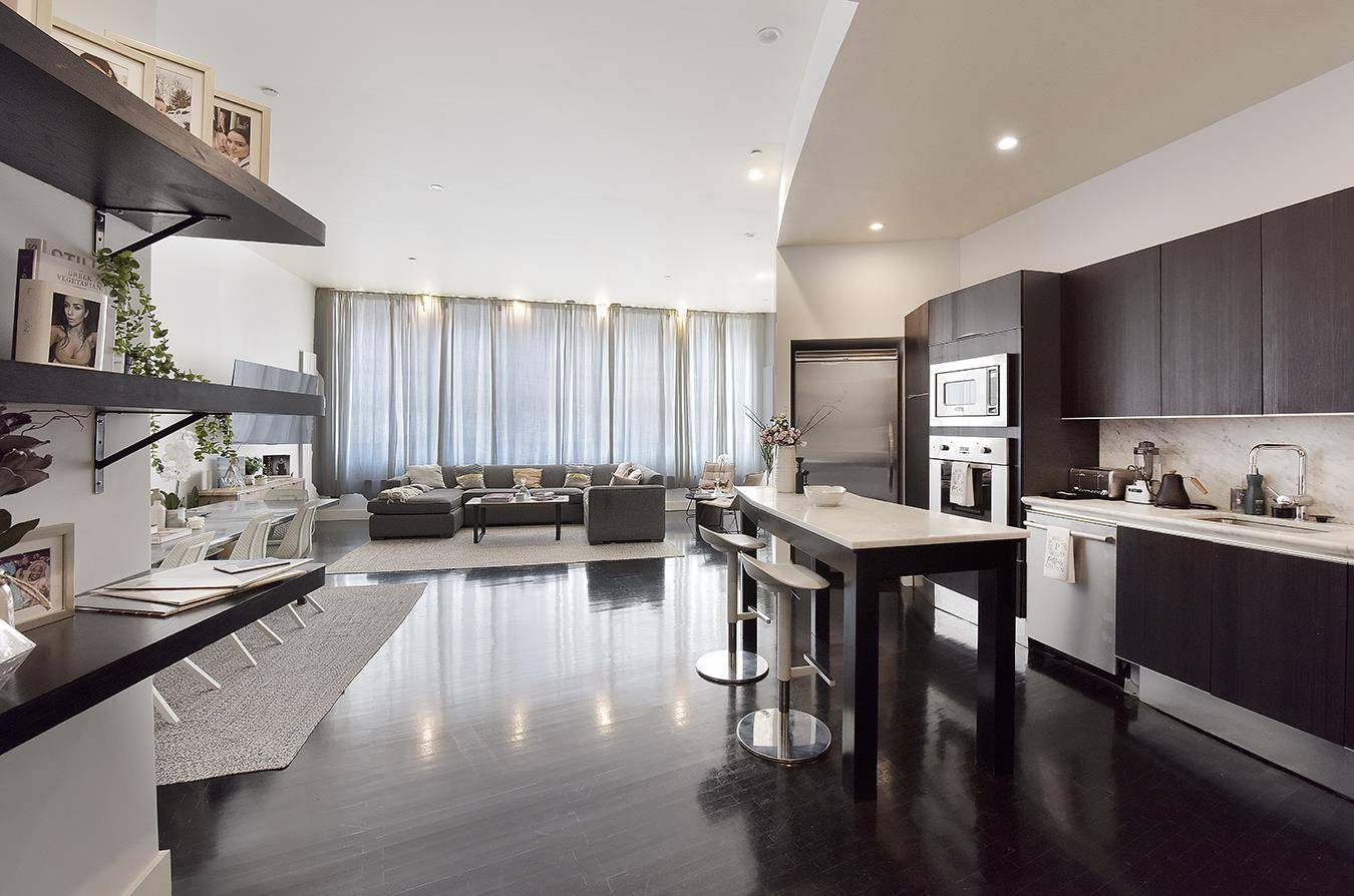 This 2200 sq ft condo loft has 11' ceilings, 3 Bedrooms, massive south facing windows, brilliant natural light, a serene private outdoor space and it is pin drop quiet.