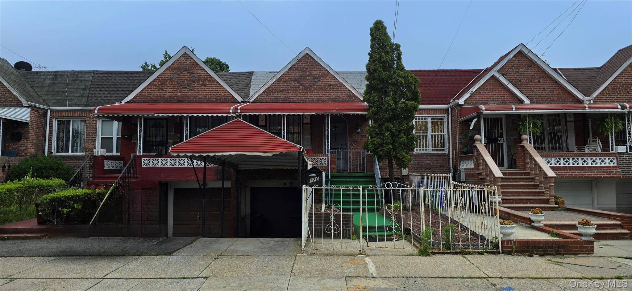 Two Family brick house with private driveway and garage.