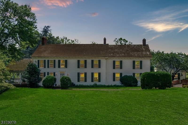 A private drive leads to this 5 bedroom, 3 full bath sunlit Colonial set on 5.