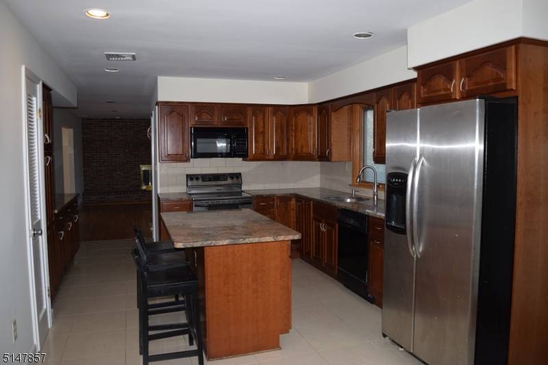 Great location Upgrades galore Spacious brick front colonial on a corner lot Cherry granite custom Kitchen with Stainless steel appliances Hardwood floors throughout the house.