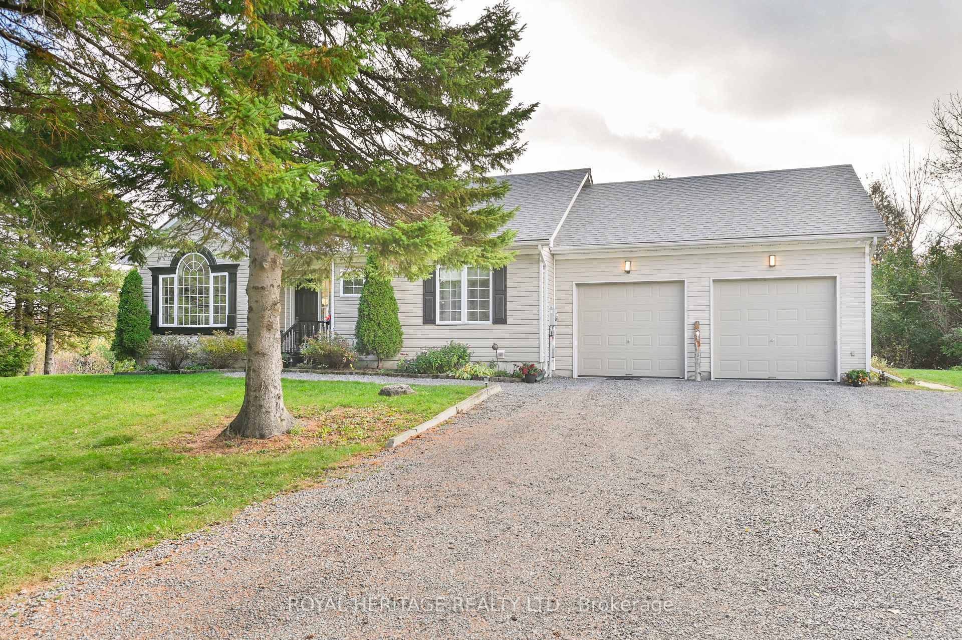 Nestled among mature trees and rolling hills, this custom built bungalow offers the perfect blend of comfort, privacy, and natural beauty on over 5.