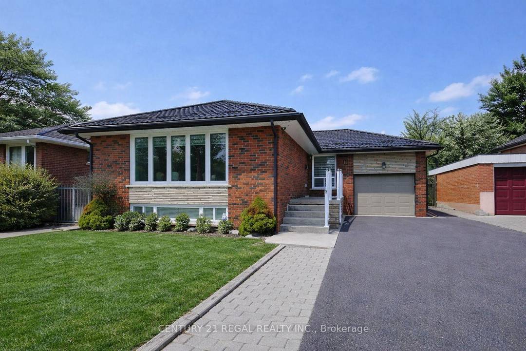 Beautiful All Brick 3 Bedroom Detached Bungalow Featuring a Sleek Metal Roof and Attached Garage.
