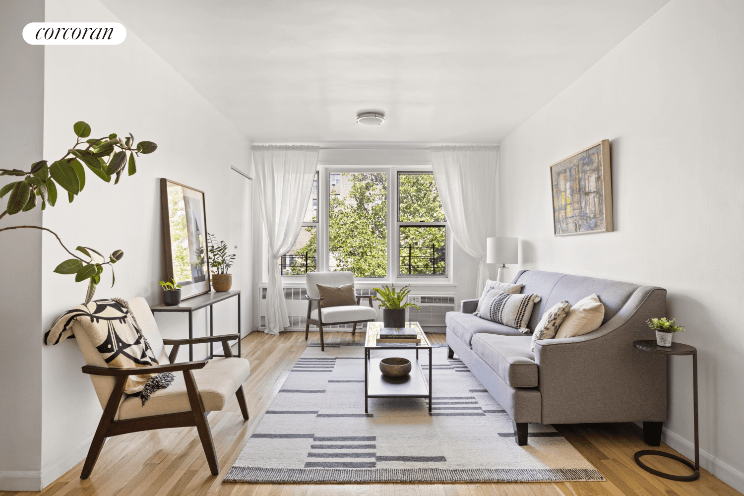 A wall of windows anchors this top floor apartment, with western sunshine that filters through swaying treetops to welcome you home.