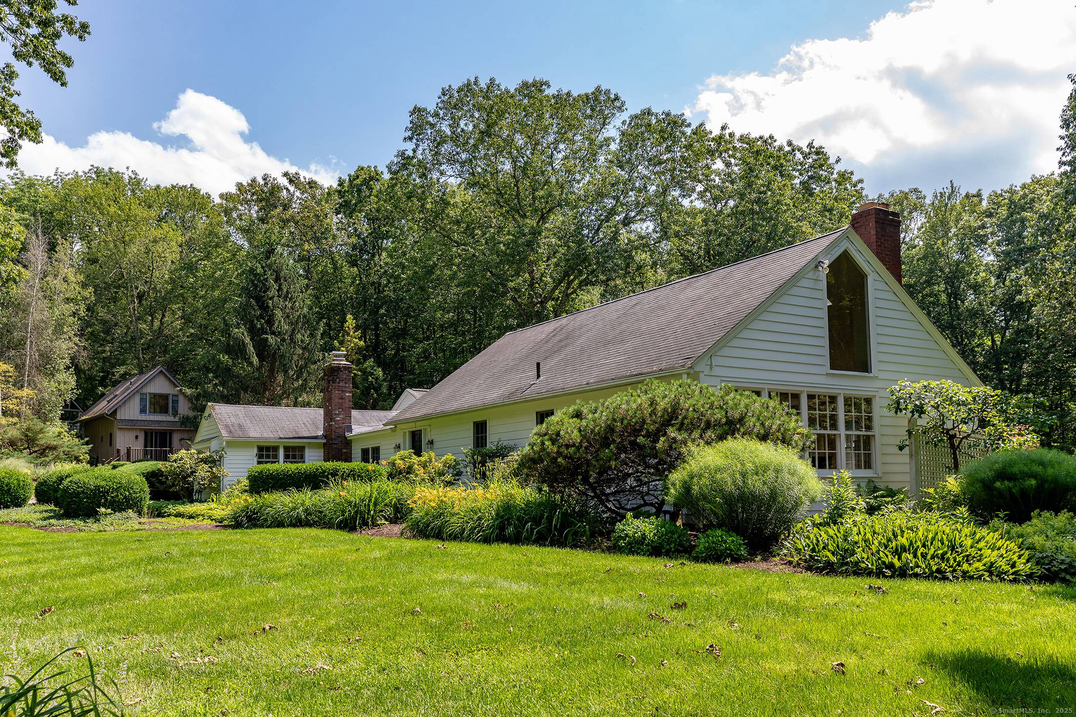 Charming 3 bedroom, 3 bathroom, cottage on a private 13 acres with a heated saltwater gunite pool, guest cottage, stunning grounds, and perennial gardens.