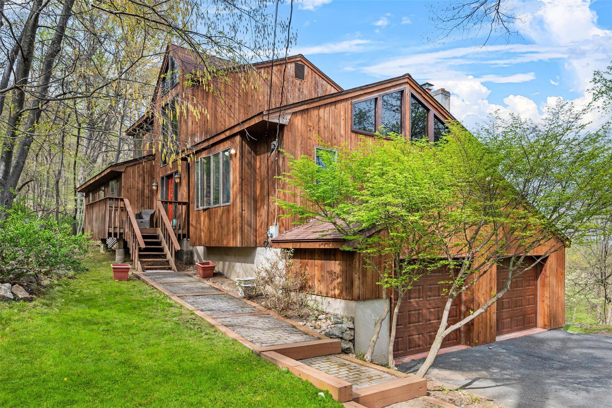 Nestled among trees with picturesque woodland views, this custom built colonial contemporary home offers a versatile layout ideal for today's flexible living needs.