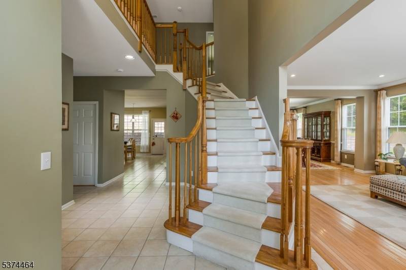This brick front, 2 story, traditionally styled colonial home is perched nicely above the curb enjoying winter views with a forested, rear privacy border.