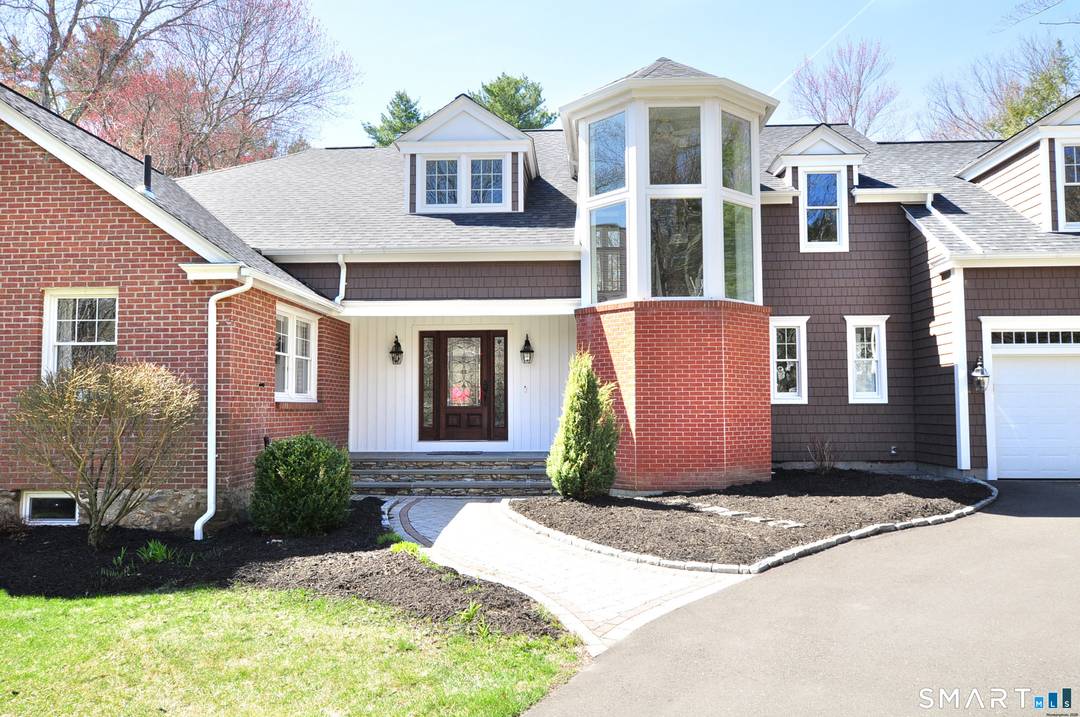 Set along a quiet, tree lined stretch of Indian Hill Road, this exceptional Canton residence offers a refined blend of heritage and modern luxury.