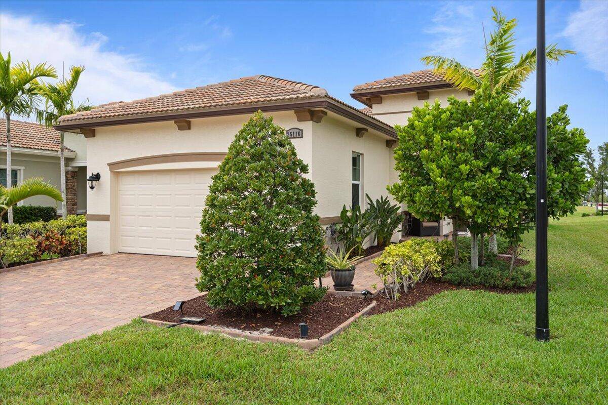 Gorgeous ''Arezzo'' Model with Lake View fenced in yard on corner lot at Verano PGA Village.