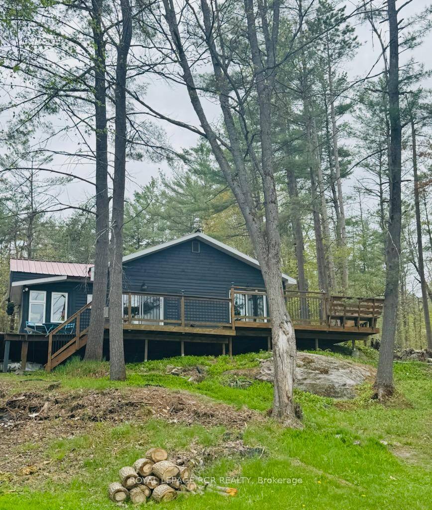Year round cottage or full time home nestled on a large 100 x 391 ft waterfront lot on Gloucester Pool Maclean Lake.
