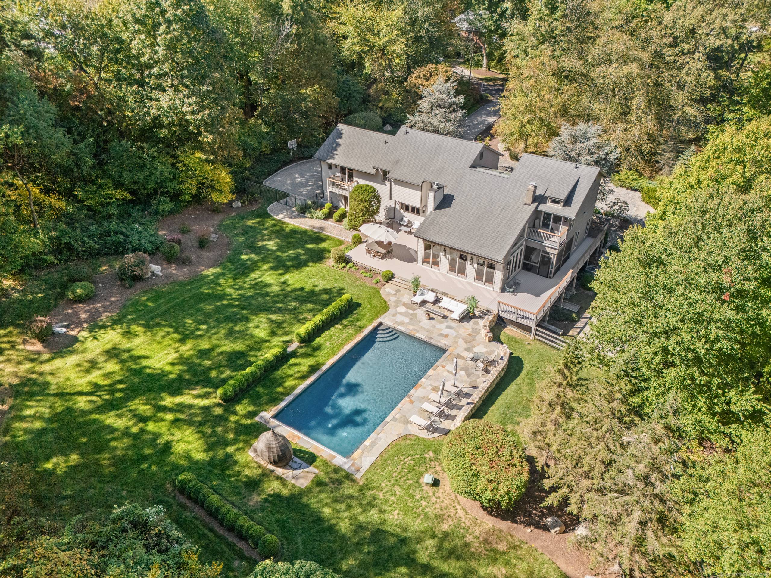 Set on more than two acres of exquisite, park like property in the coveted Red Coat estate section of Westport, this spectacular modern home with a glorious gunite pool offers ...