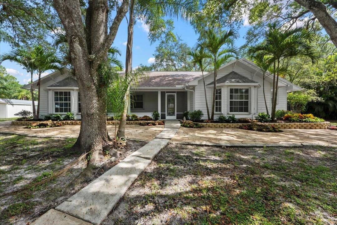 Rare opportunity to own TWO homes on 2 fully fenced acres in the desirable equestrian community of Jupiter Farms.