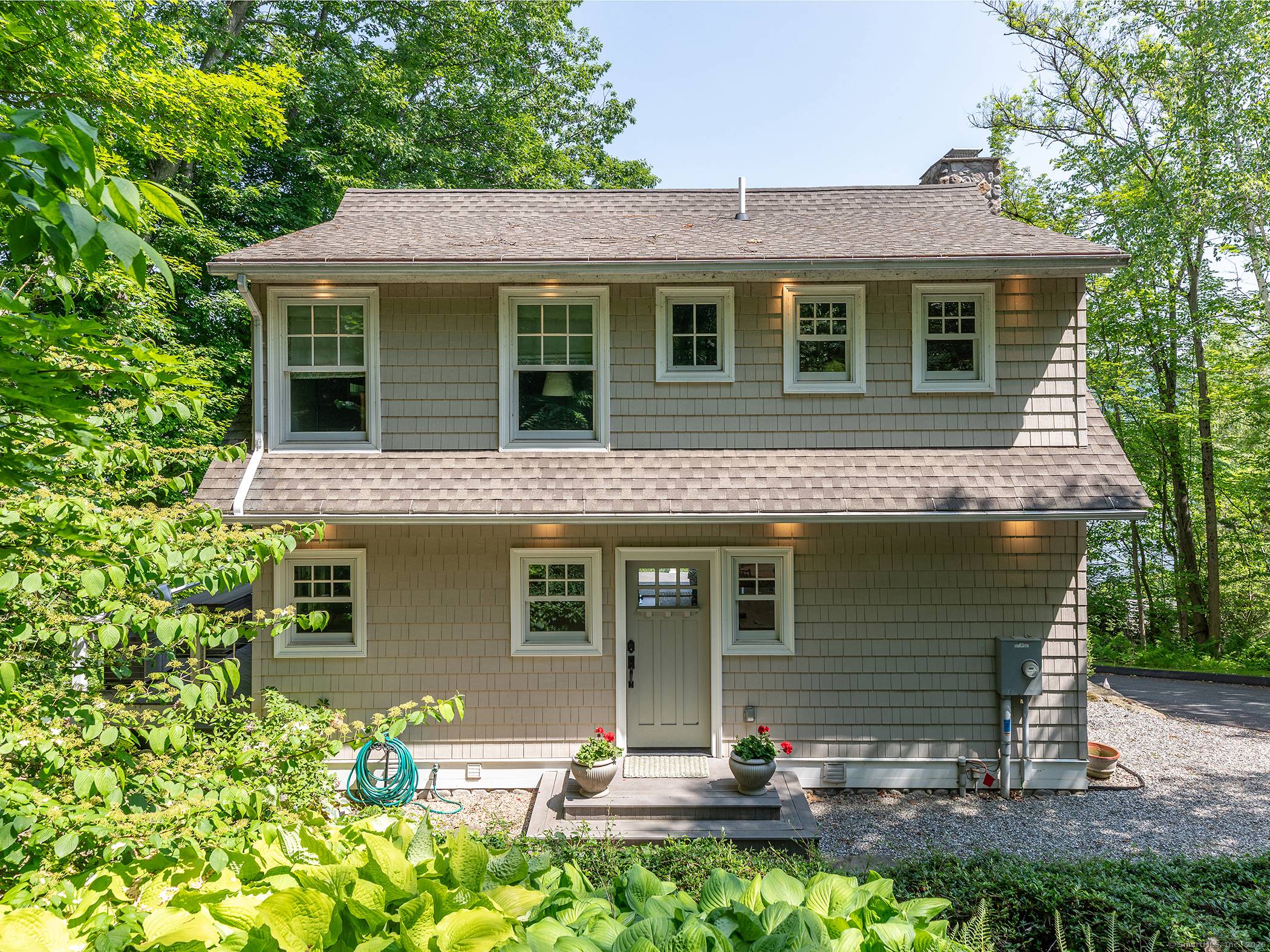 Escape to this incredibly charming Lake Waramaug cottage offering exceptional views from every window.