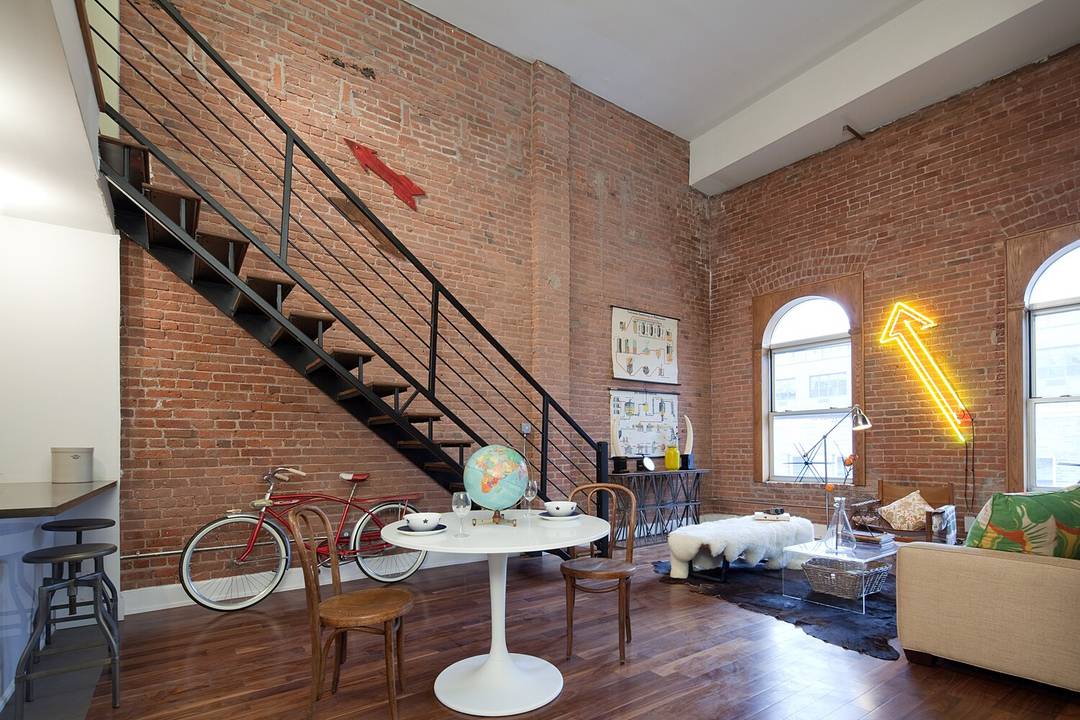 This authentic Factory Loft Conversion features 17 foot soaring ceiling height, a full wall of exposed brick and so much more.