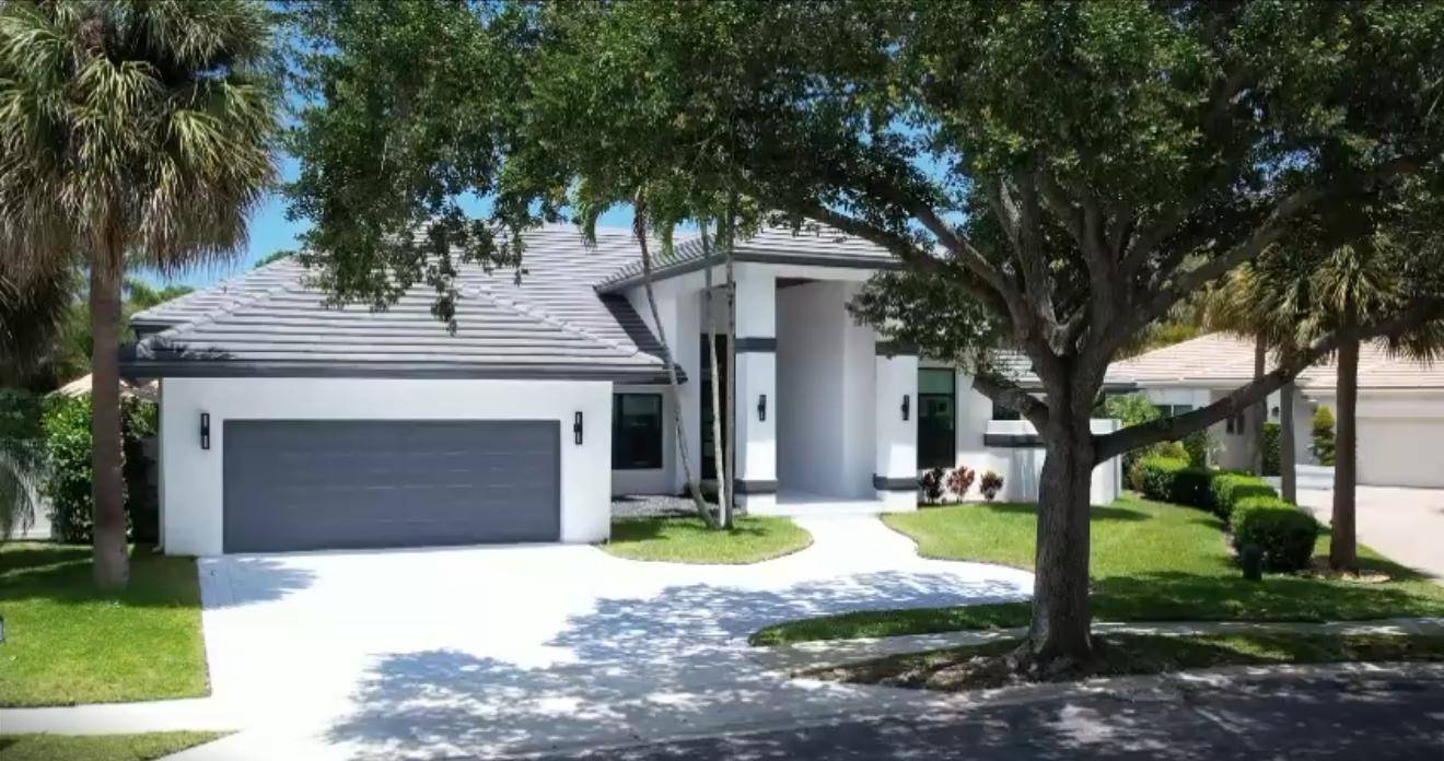 This fully renovated contemporary estate is nestled in the prestigious Water Oak Estates of Broken Sound Golf and Country Club, offering a perfect blend of modern luxury and serene privacy.