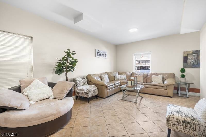 Modern multi family built in 2012 featuring 6 bedrooms and 5 bathrooms, central air, and spacious layouts throughout.