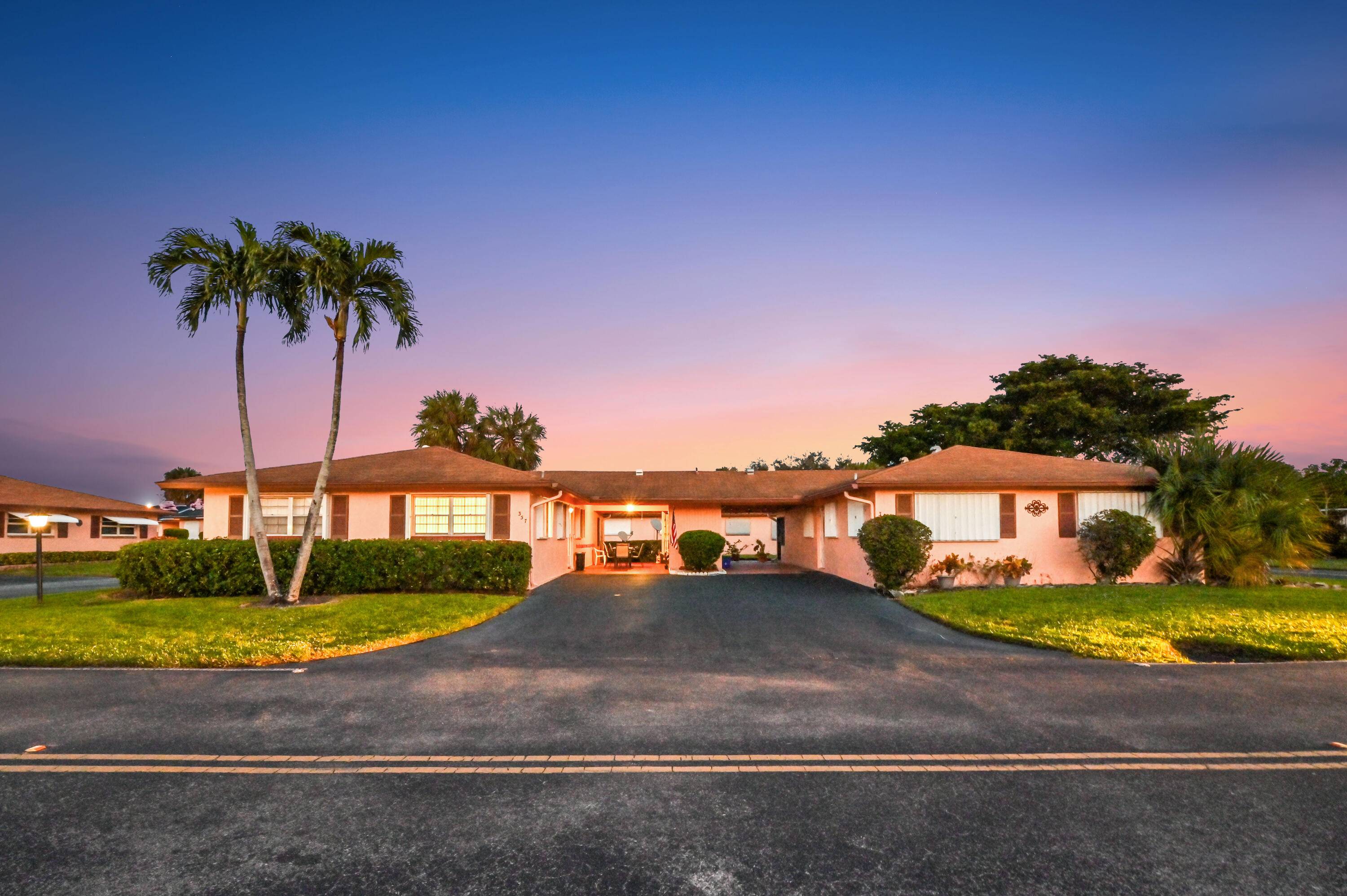 Situated within the serene 55 community of Country Manors, find your treasured haven at 357 Flamingo Lane, Delray Beach.