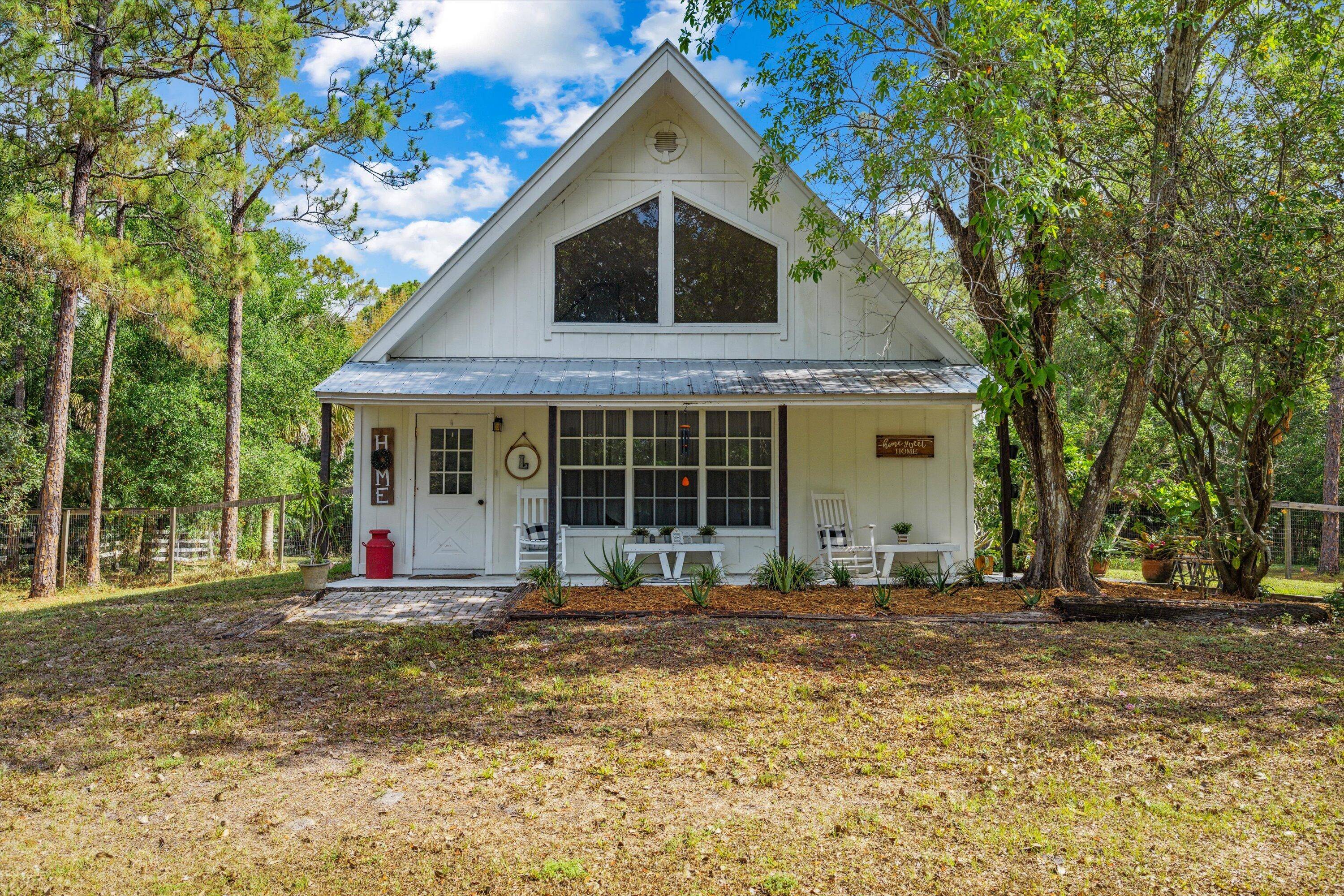 Tucked away on a quiet street in Jupiter Farms, this cozy A frame home offers the perfect blend of natural beauty, functional updates, and laid back Florida living.