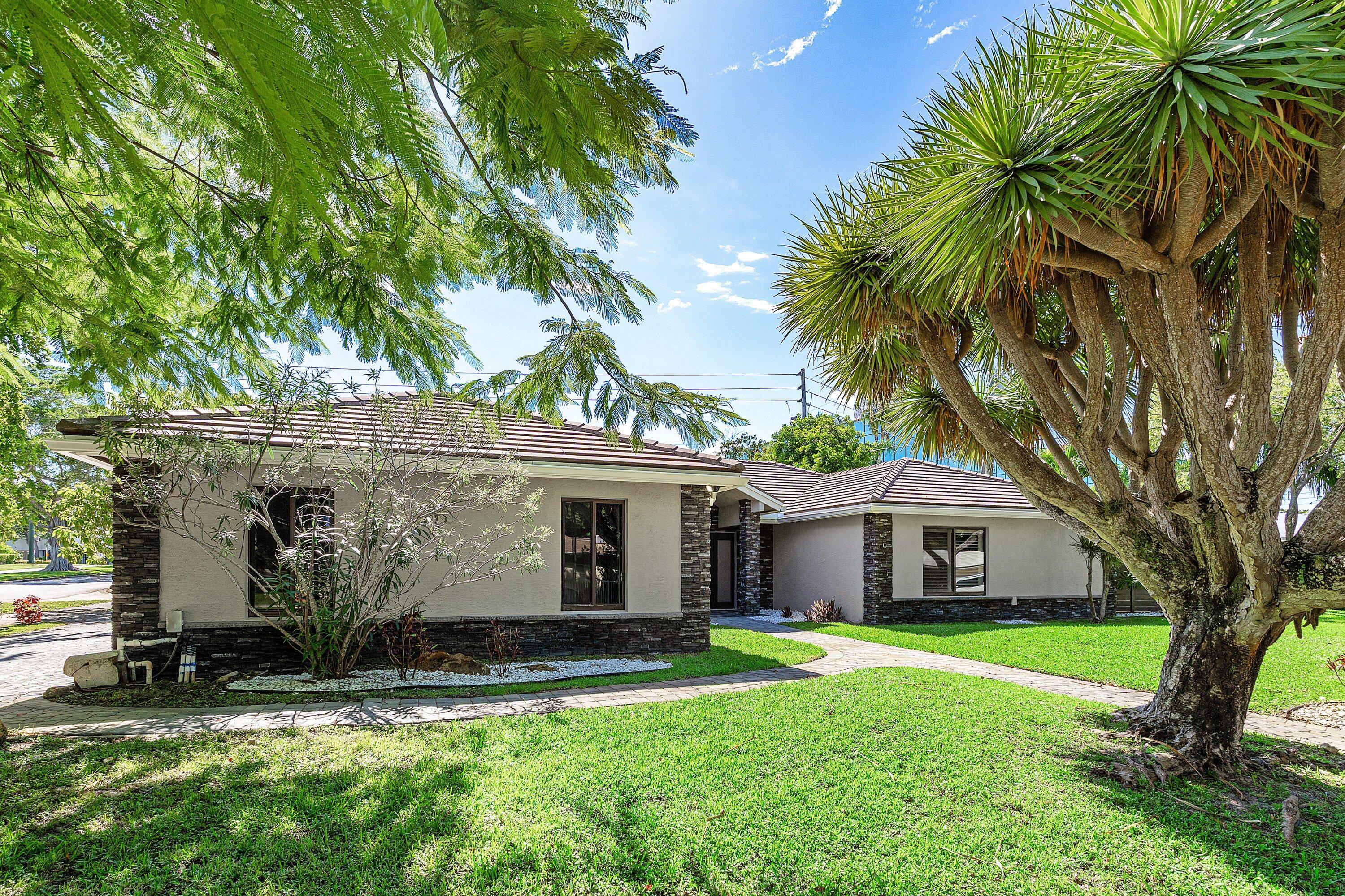 Extensively renovated home with redesigned exterior, added interior enclosure bath, pool remodel, pavers, new fence, faux finish garage door, tile floors, crown molding oversized baseboards.