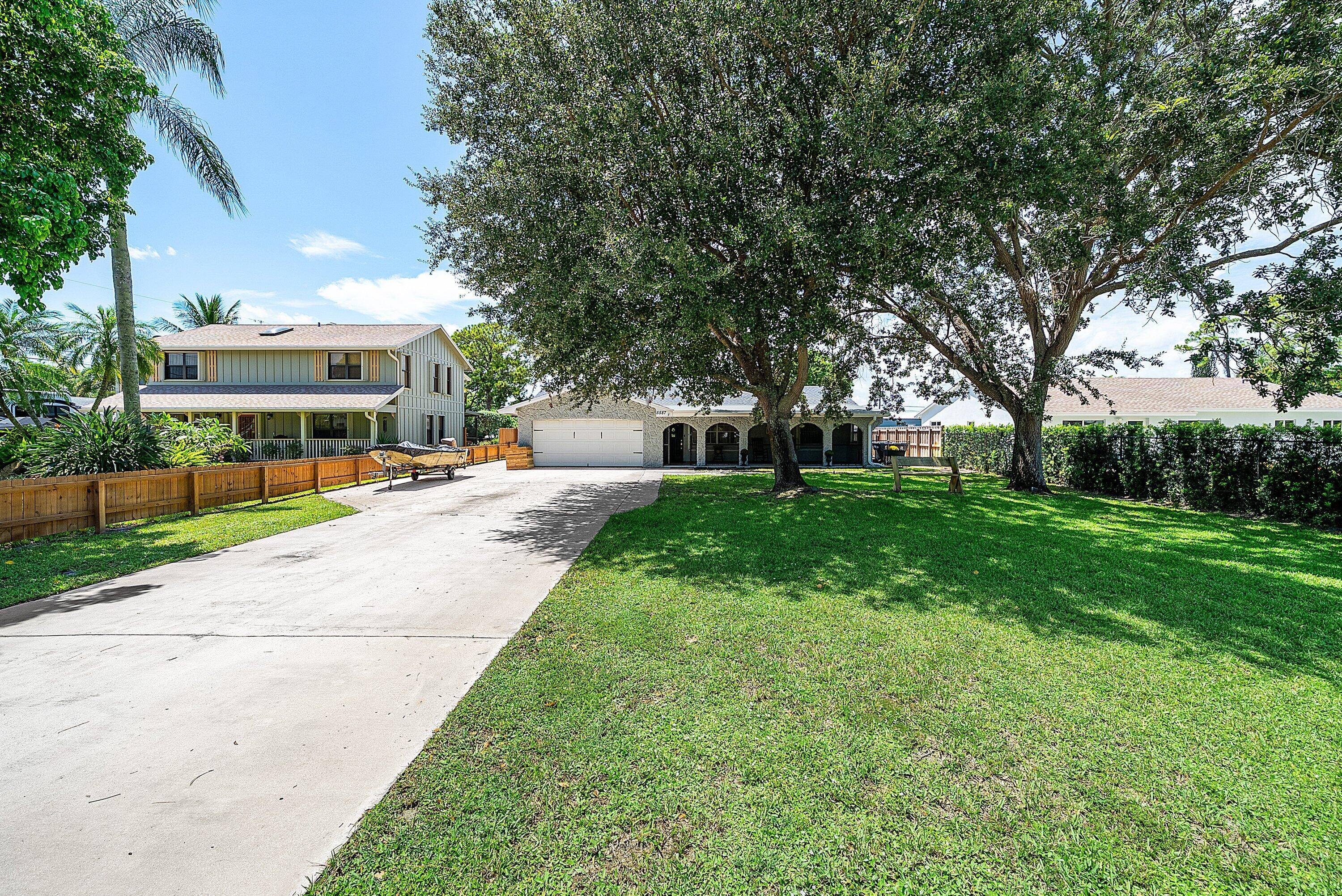 Discover the perfect blend of charm and modern living on a 1 2 acre in Palm Beach County.