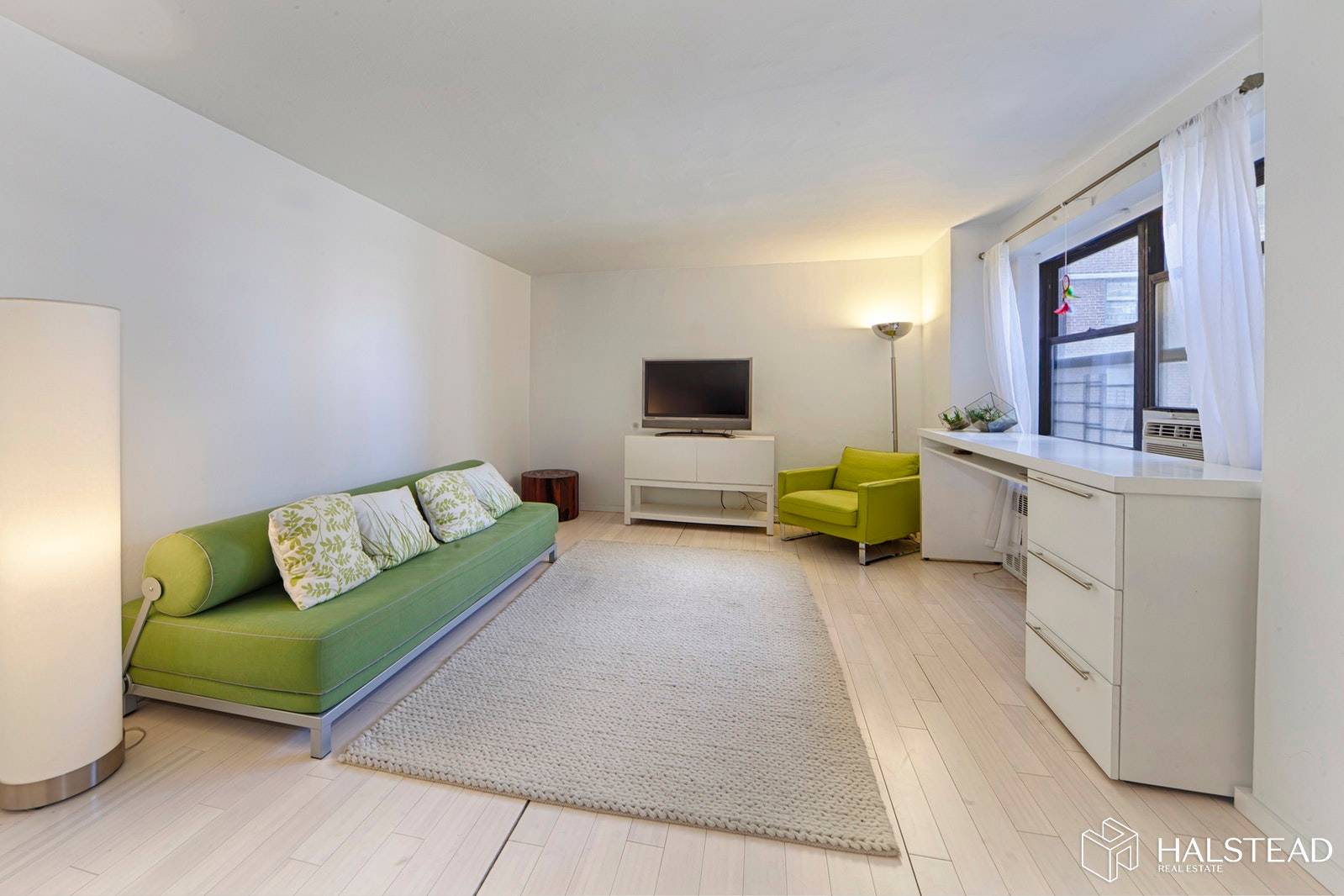 Airy and expansive studio with wide plank bamboo flooring, fully renovated windowed eat kitchen, and a fully renovated bath !
