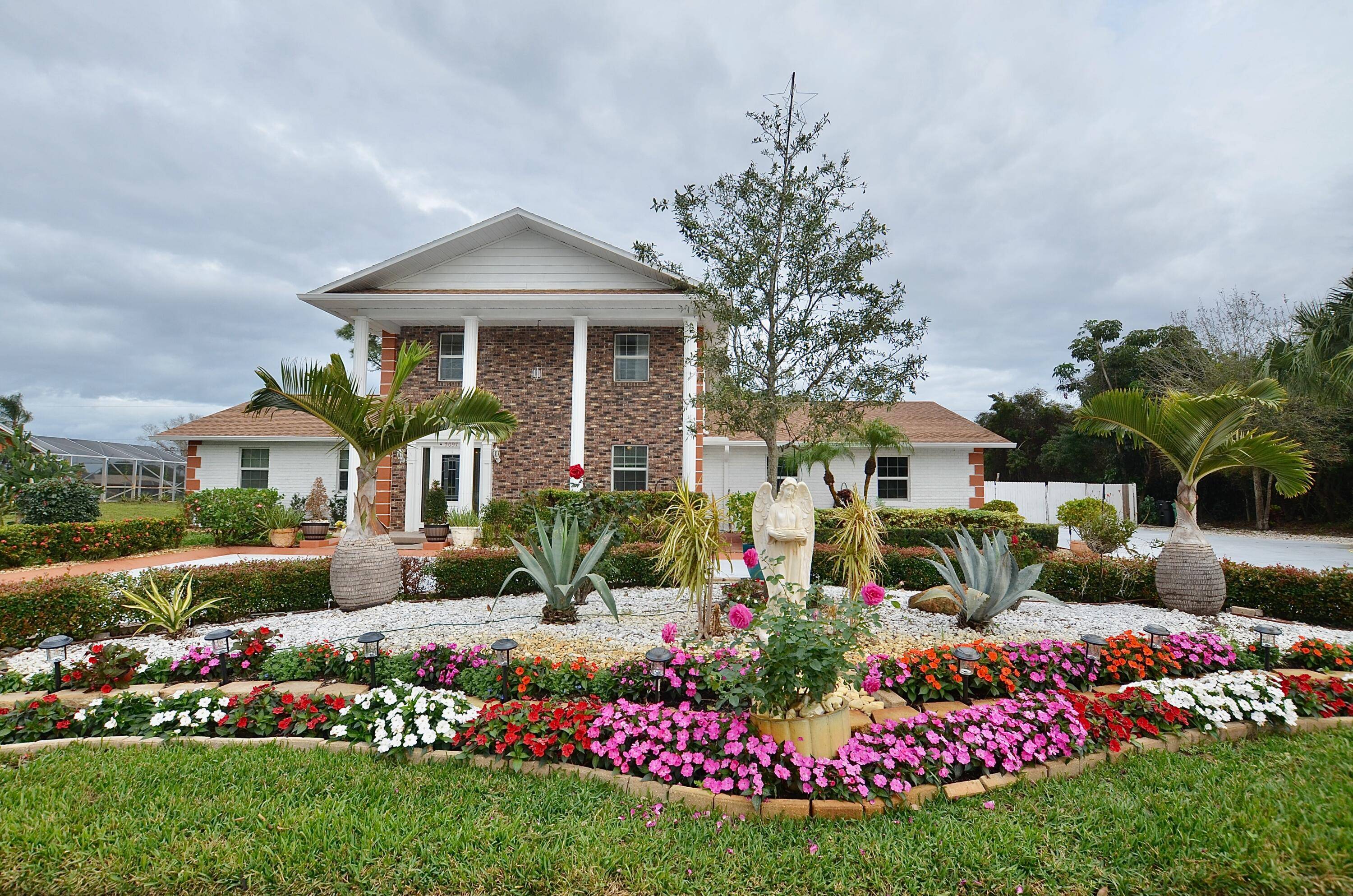 Majestic Southern Colonial Estate with Modern UpgradesStep into timeless elegance with this Southern Colonial style estate, beautifully set on an expansive lot.