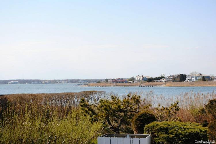 This spacious 2 bedroom, 2 bath Dune Road bayfront condo has amazing views of Moriches Bay and the evening sunsets.