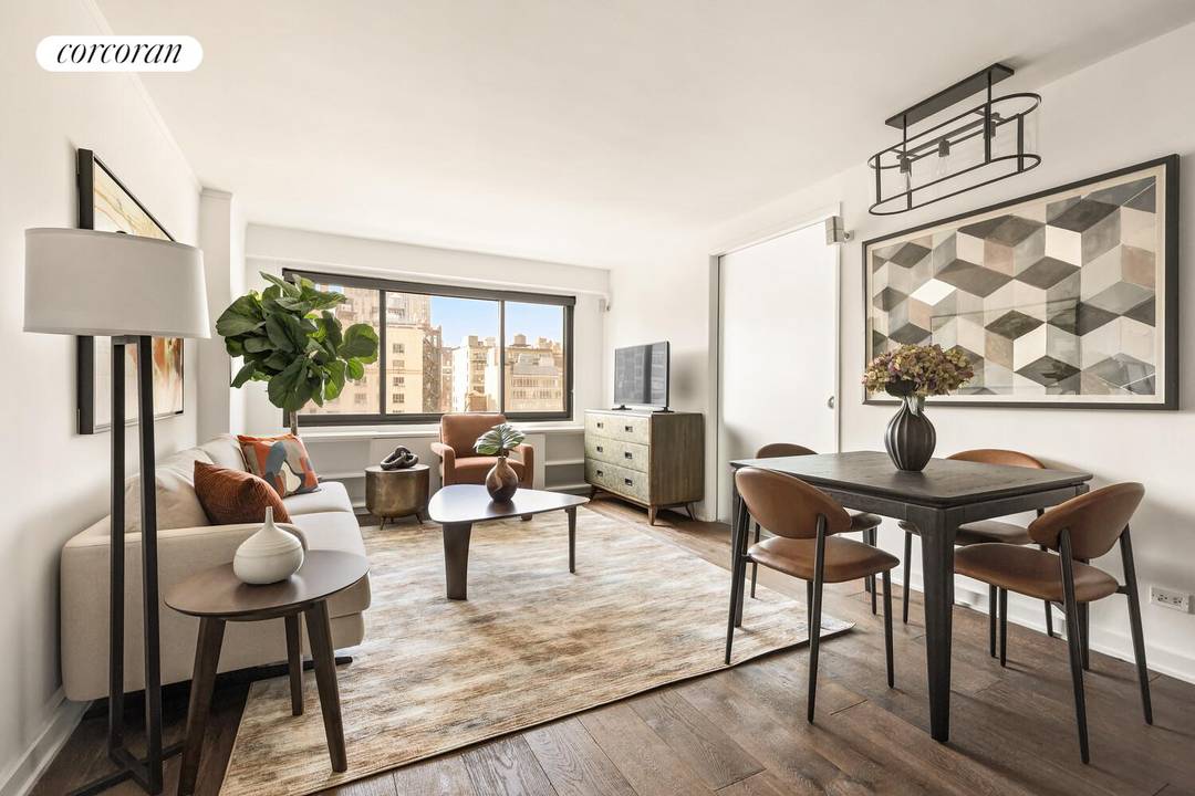 Experience southern light and sweeping city views from this high floor one bedroom home at 201 West 21st Street, Apartment 12J, in the heart of Chelsea.