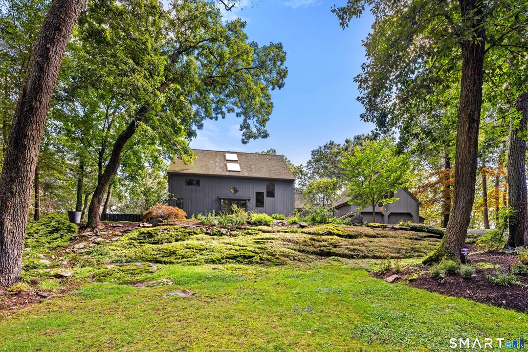 Set privately in Weston, this extraordinary home is an early masterpiece by Michael Greenberg, featuring a meticulously relocated Vermont barn, rebuilt with exceptional care and craftsmanship.